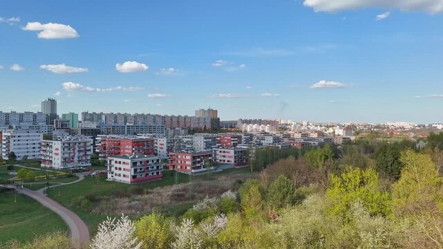 Panoramic drone view of Prague 4 residential district in spring. aerial shot captures the diverse architecture of the Prague blooming spring trees, and walking paths weave through the urban landscape