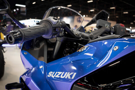 Blue Suzuki GSX-8R sportbike, full fairing design and exposed trellis frame, presented at a motor show.