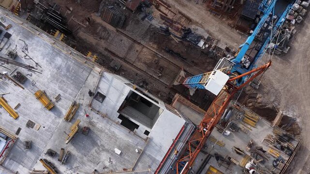 Drone aerial view of construction site with building structure and development progress