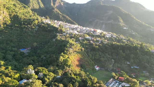 historic mayan village in lake atitlan guatemala (santa cruz la laguna) small homes maya residents side of mountain volcanic caldera volcano travel tourism poverty traditional native aerial