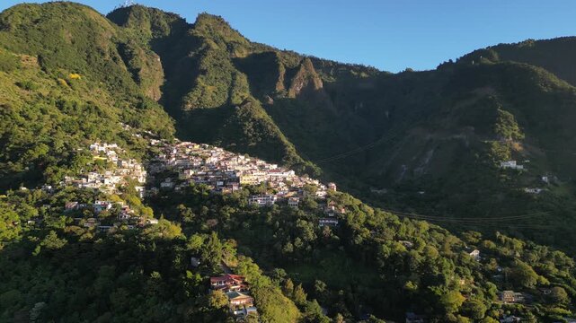 historic mayan village in lake atitlan guatemala (santa cruz la laguna) small homes maya residents side of mountain volcanic caldera volcano travel tourism poverty traditional native aerial