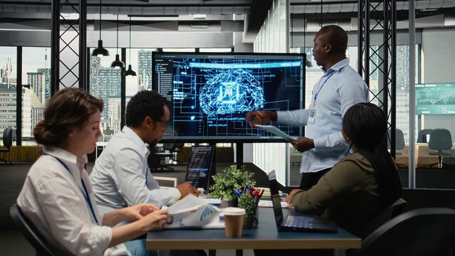 Tech startup office manager doing presentation on neural network technology to potential investors. African american man using display to show business shareholders latest AI innovations, camera A