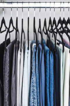 women trousers jeans and yoga pants in decluttered organized wardrobe