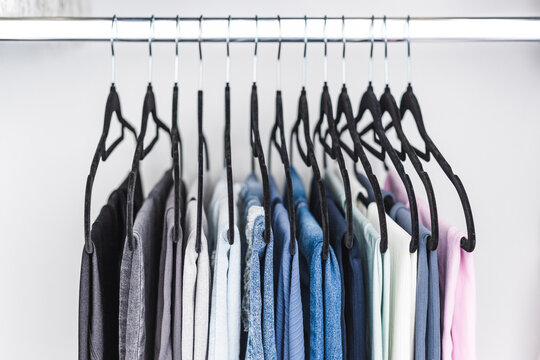 women trousers jeans and yoga pants in decluttered organized wardrobe