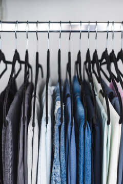 women trousers jeans and yoga pants in decluttered organized wardrobe