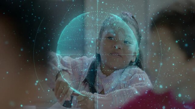 Girl responding to classroom prompt, raising hand, writing with pencil as turquoise globe orbiting