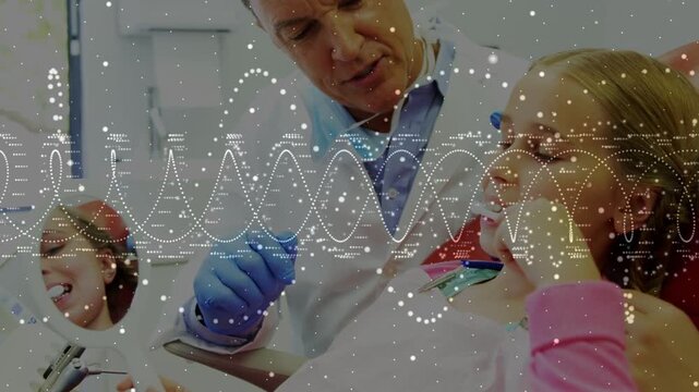 Mature male dentist leaning, inspecting female child patient in dental clinic with mirror, overlay