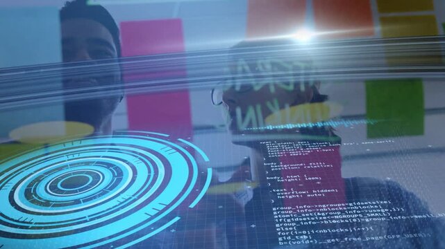 Pair reaching and pointing at glass, blue HUD aligning sticky notes and code, planning tech roadmap