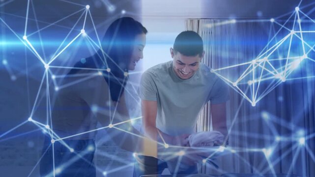 Pair folding clothes in hotel, blue network overlay framing hands and phone during trip packing