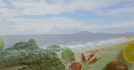 Fototapeta premium Blending curving beach and breaking waves with translucent lettuce limes orange chilies rocky bluff