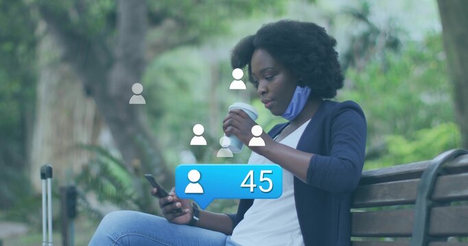 Scrolling woman in navy blazer on park bench, holding smartphone, coffee, suitcase, notification 45