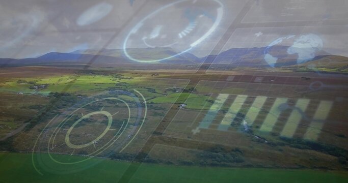 Displaying aerial farmland showing fields, hedgerows, winding road toward low mountains, with HUD