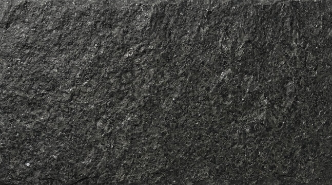 Close-up view of a dark gray natural slate stone surface with a rough, uneven, and granular texture pattern