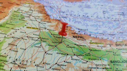 Fototapeta premium View of Lucknow, is a metropolis and the second largest city of the Indian state of Uttar Pradesh, on a geographical map of Asia, marked with red pushpin
