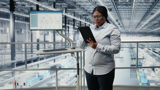 Portrait of smiling woman in microchip factory developing advanced electronics automation process. Happy African american female engineer using EDA software to optimize semiconductor design, camera A