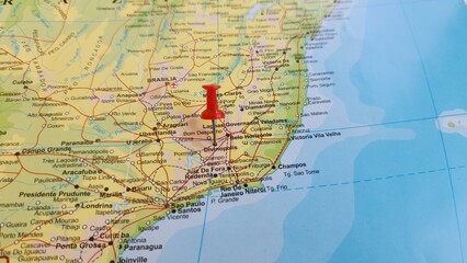 Obraz premium View of Divinopolis, is a municipality in the centre-west of Minas Gerais state, Brazil, on a geographical map of America, marked with red push pin