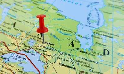 Obraz premium View of Nakina, is a community in the Town of Greenstone in the Thunder Bay District in Northern Ontario, Canada, on a geographical map of America, marked with red push pin