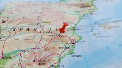 Obraz premium View of Albacete, is a city and municipality in the Spanish autonomous community of Castilla–La Mancha, and capital of the province of Albacete on a geographical map of Europe, marked with red pin