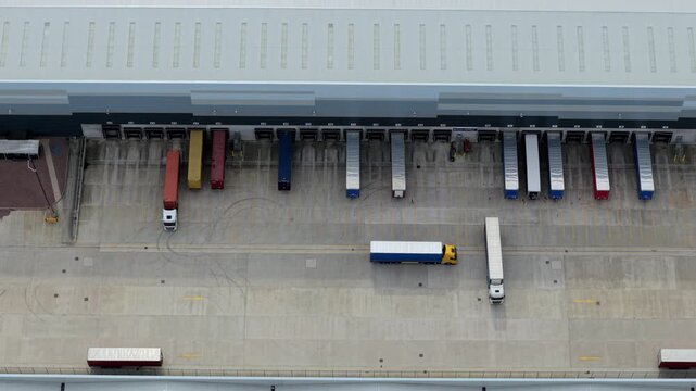 Aerial view of Appleby Magna Industrial Park with trucks parked at loading docks and trailers moving across the yard in Appleby Magna, England, United Kingdom.