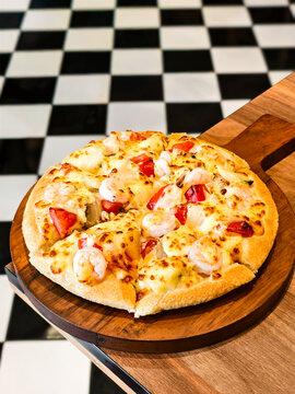Close up of tropical seafood pizza served in a retro diner setting.