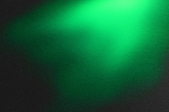 Emerald Luminescence: Abstract image features a radiant green light emanating from the top corner, casting a soft glow across a textured black background.