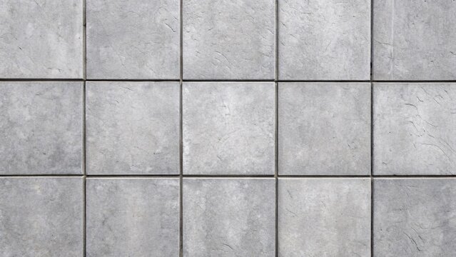 Gray concrete tiles with square pattern and grout lines