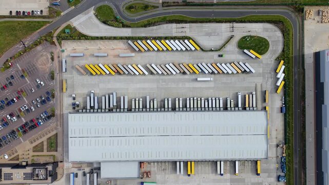 Aerial view of Appleby Magna Industrial Park showing rows of parked semi-trailers and a large warehouse facility with surrounding roads in Appleby Magna, England, United Kingdom.