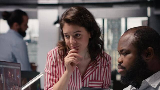 Diverse editors using AI wireframe for clips montage production, using software toolbar with sliders and controls to demonstrate machine learning, data processing and artificial intelligence tech.