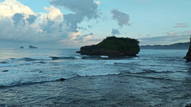 Tropical Coastal Landscape at Tanjung Penyu Beach with Small Islands, Waves and Serene Ocean View in Indonesia