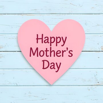 pink heart with text Happy Mother's Day with pastel blue wooden background