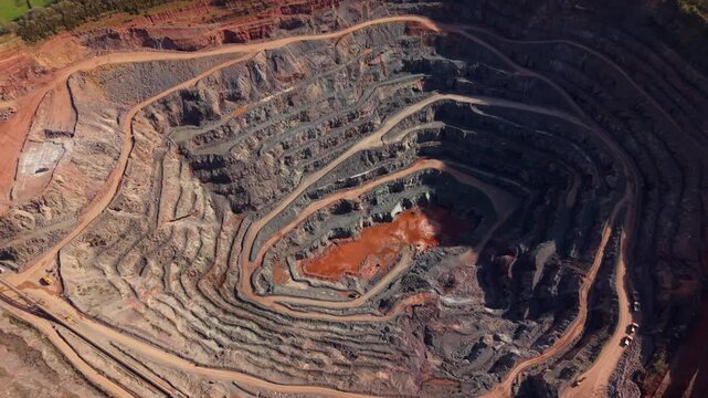 Aerial view of Old Cliffe Hill quarry showing deep terraced rock walls and industrial machinery in Stanton under Bardon, England, United Kingdom.