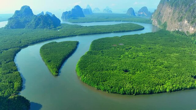 Aerial perspective of mangrove island shaped like a heart symbolizes rich estuarine habitats, scenic geology, ecological balance, and nature preservation. Samet Nangshe, Phang Nga, Thailand. 4k.

