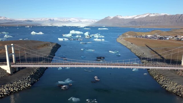Aerial view of Jokulsarlon lagoon with drifting icebergs and clear blue water in Iceland