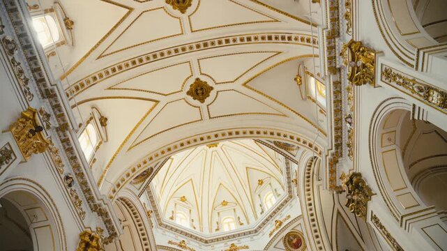 Detailed view of an ornate cathedral ceiling in Altea, Spain, featuring elegant arches and golden decorations. Bright, classical architecture with a refined and historic atmosphere.