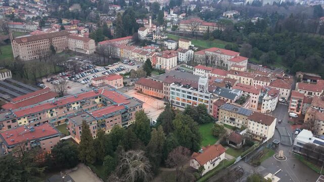 Aerial drone footage featuring a smooth rotating approach toward Lanificio Conte, a historic industrial complex in Schio, Italy.