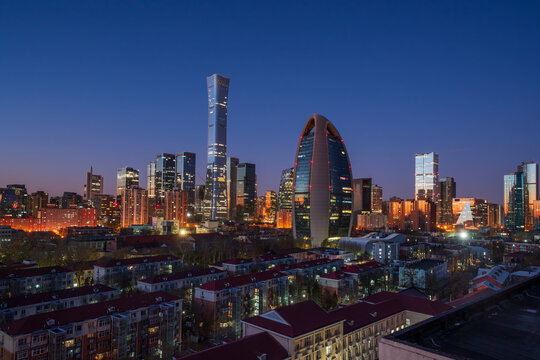 Morning blue hour over the Beijing CBD skyline featuring CITIC Tower (China Zun) and People's Daily Building, showcasing modern urban development