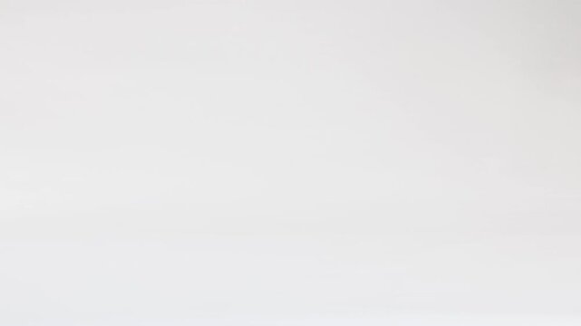 Yellow Tennis Ball Bouncing Across a Plain White Background