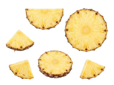 Vibrant photograph of fresh pineapple slices and wedges, beautifully arranged and isolated on transparent background.