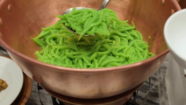 Serving Traditional Thai Lod Chong Pandan Noodles from a Copper Pot