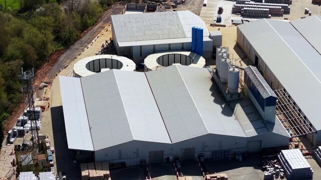 Aerial view of a concrete production supplier facility with industrial warehouses and silos in Ellistown, England, United Kingdom.