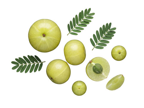 Fresh Indian gooseberries (amla) with green leaves, whole and sliced, on a transparent background.