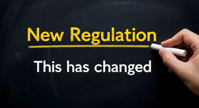 Hand writing new regulation this has changed on chalkboard