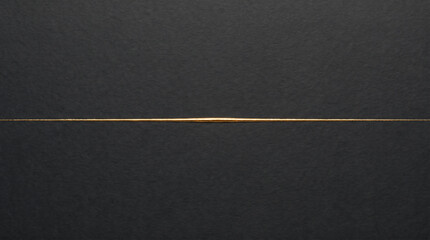 Fototapeta premium Minimalist elegant background with a thin glowing gold line over a dark textured black paper surface.