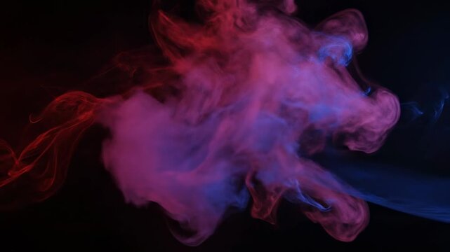 Abstract composition depicting vibrant red and blue plumes of smoke on a stark, black background