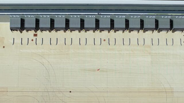 Aerial view of the loading docks and concrete yard of a new supermarket distribution centre with industrial architecture Nuneaton, England, United Kingdom.