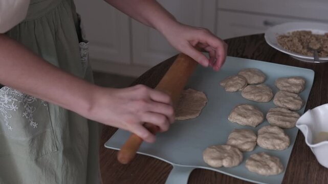 A woman is preparing dough for cookies