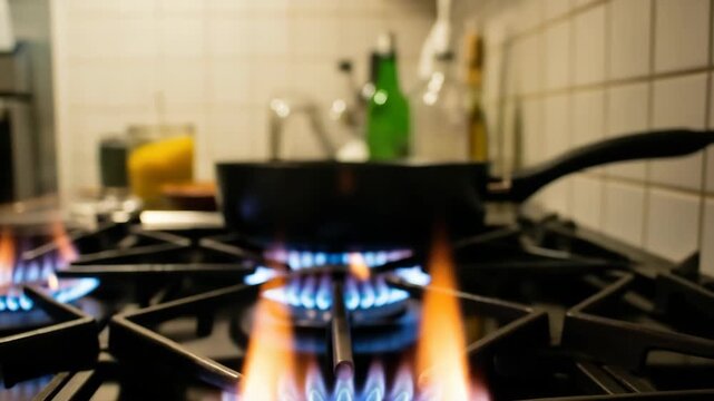 Close-up Of Burning Gas Stove Flames In Kitchen Setting With Pan Other Blurred Kitchen Items In The Background For Cooking Illustrations