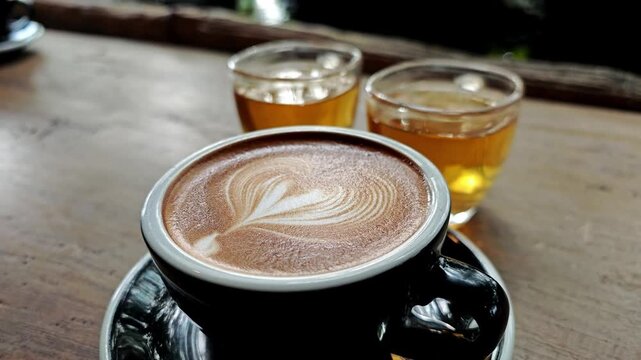 Close up of latte art creation, milk poured from a mug.