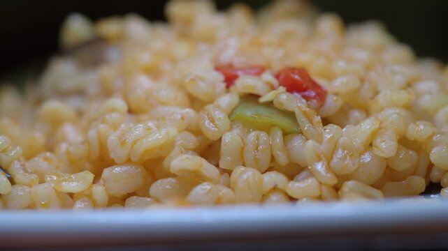 Cooking bulgur wheat with vegetables in the kitchen