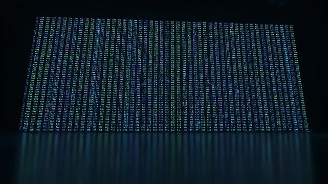 A wall of abstract digital text, with reflections, in blue and green tones